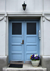Image showing Beautiful blue door and flowers