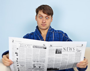 Image showing Man reads a newspaper with a admiration