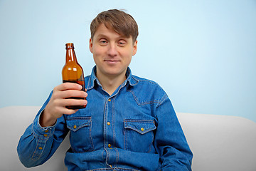 Image showing Man relaxing with a bottle of beer