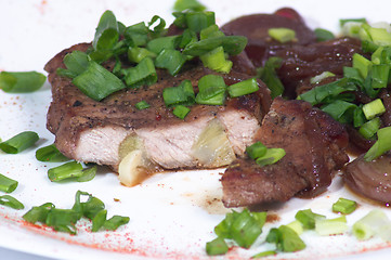 Image showing Grilled pork steak on white plate.