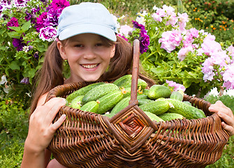 Image showing Little girl and cucumbers