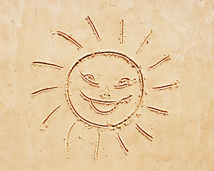 Image showing Smiling sun. Drawing on sand