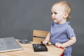 Image showing child working at open hard drive