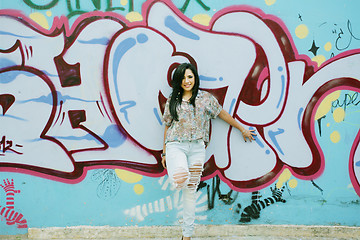 Image showing Girl against grafitti wall