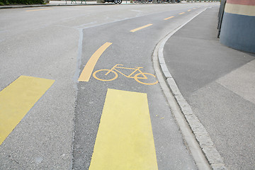 Image showing Yellow painted sign for bikes on asphalt 