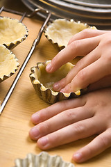 Image showing Detail of child hands making cookies