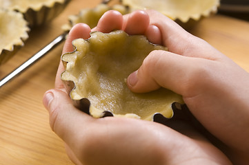 Image showing Detail of child hands making cookies