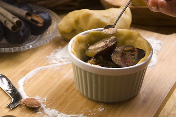 Image showing Detail of child hands making plum tart