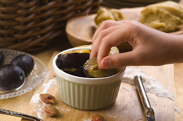 Image showing Detail of child hands making plum tart