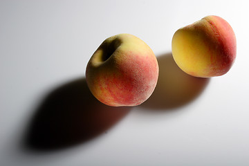 Image showing Two peaches and their shadows