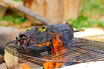 Image showing eggplant roasting in flames