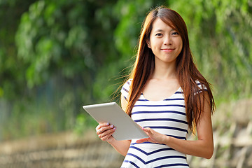 Image showing young woman using tablet touch computer