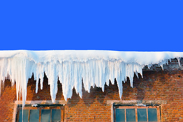 Image showing Snow cover on roof of old textile fabric with icicles