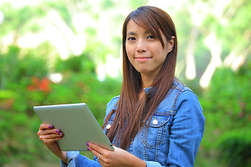 Image showing young woman using tablet touch computer