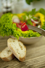 Image showing fresh tasty healthy mixed salad and bread on table