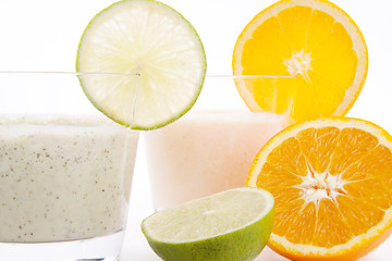 Image showing fresh tasty lime and orange yoghurt shake cream isolated