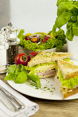 Image showing fresh tasty club sandwich with cheese and ham on table