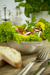 Image showing fresh tasty healthy mixed salad and bread on table