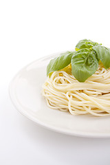 Image showing fresh delicious pasta with basil isolated on white