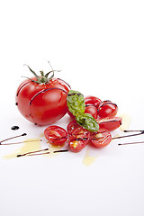 Image showing fresh red tomatoes with balsamic and oilve oil isolated