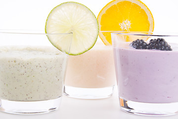 Image showing fresh tasty lime and orange yoghurt shake cream isolated