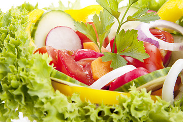 Image showing fresh tasty mixed salad with different vegetables isolated