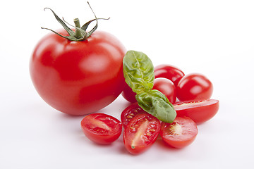 Image showing fresh red tomatoes with balsamic and oilve oil isolated