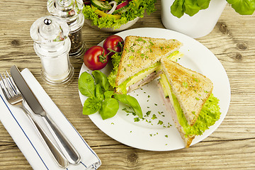 Image showing fresh tasty club sandwich with cheese and ham on table