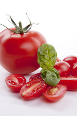 Image showing fresh red tomatoes with balsamic and oilve oil isolated