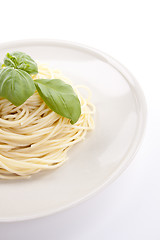 Image showing fresh delicious pasta with basil isolated on white