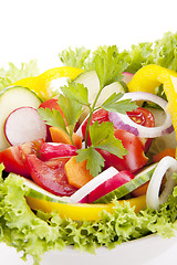 Image showing fresh tasty mixed salad with different vegetables isolated