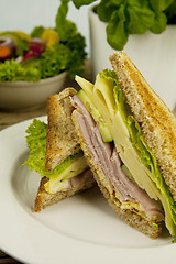 Image showing fresh tasty club sandwich with cheese and ham on table