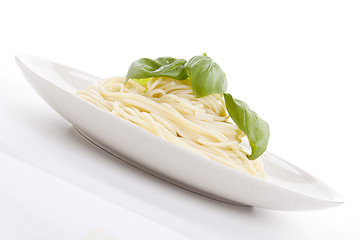 Image showing fresh delicious pasta with basil isolated on white