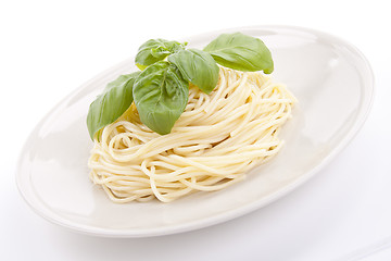 Image showing fresh delicious pasta with basil isolated on white