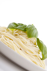 Image showing fresh delicious pasta with basil isolated on white