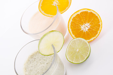 Image showing fresh tasty lime and orange yoghurt shake cream isolated