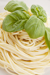 Image showing fresh delicious pasta with basil isolated on white