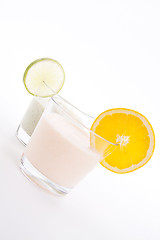 Image showing fresh tasty lime and orange yoghurt shake cream isolated