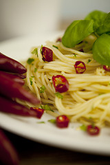 Image showing fresh pasta with basil and red chilli on table