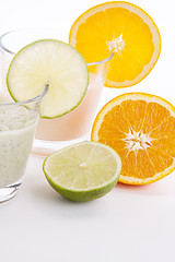 Image showing fresh tasty lime and orange yoghurt shake cream isolated