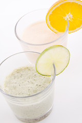 Image showing fresh tasty lime and orange yoghurt shake cream isolated
