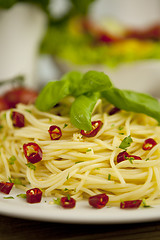 Image showing fresh pasta with basil and red chilli on table