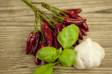 Image showing red hot chilli pepper with basil and garlic on table