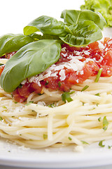 Image showing tatsty fresh spaghetti with tomato sauce and parmesan isolated