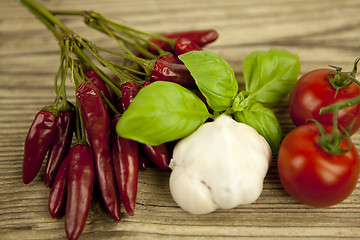 Image showing red hot chilli pepper with basil and garlic on table