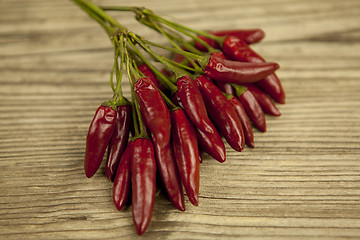 Image showing red hot chilli pepper with basil and garlic on table