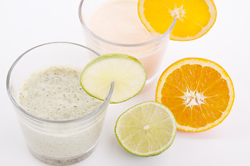 Image showing fresh tasty lime and orange yoghurt shake cream isolated