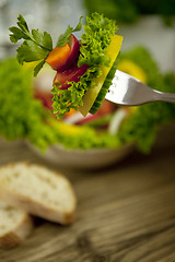 Image showing fresh tasty healthy mixed salad and bread on table