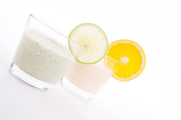 Image showing fresh tasty lime and orange yoghurt shake cream isolated