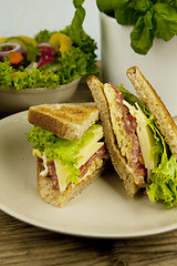 Image showing fresh tasty club sandwich with cheese and ham on table